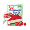 Dr. Oetker cheesecake mix packaging with a slice of cheesecake and raspberries on a green background