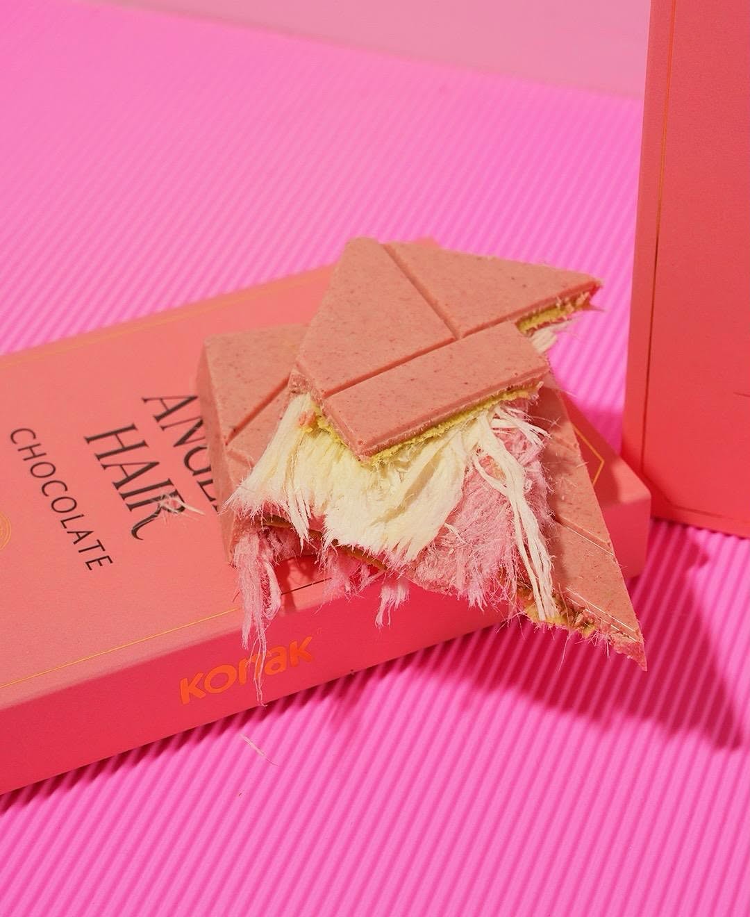 Breaking open the Angel Hair chocolate bar to reveal the soft, delicate cotton candy (pişmaniye) inside.