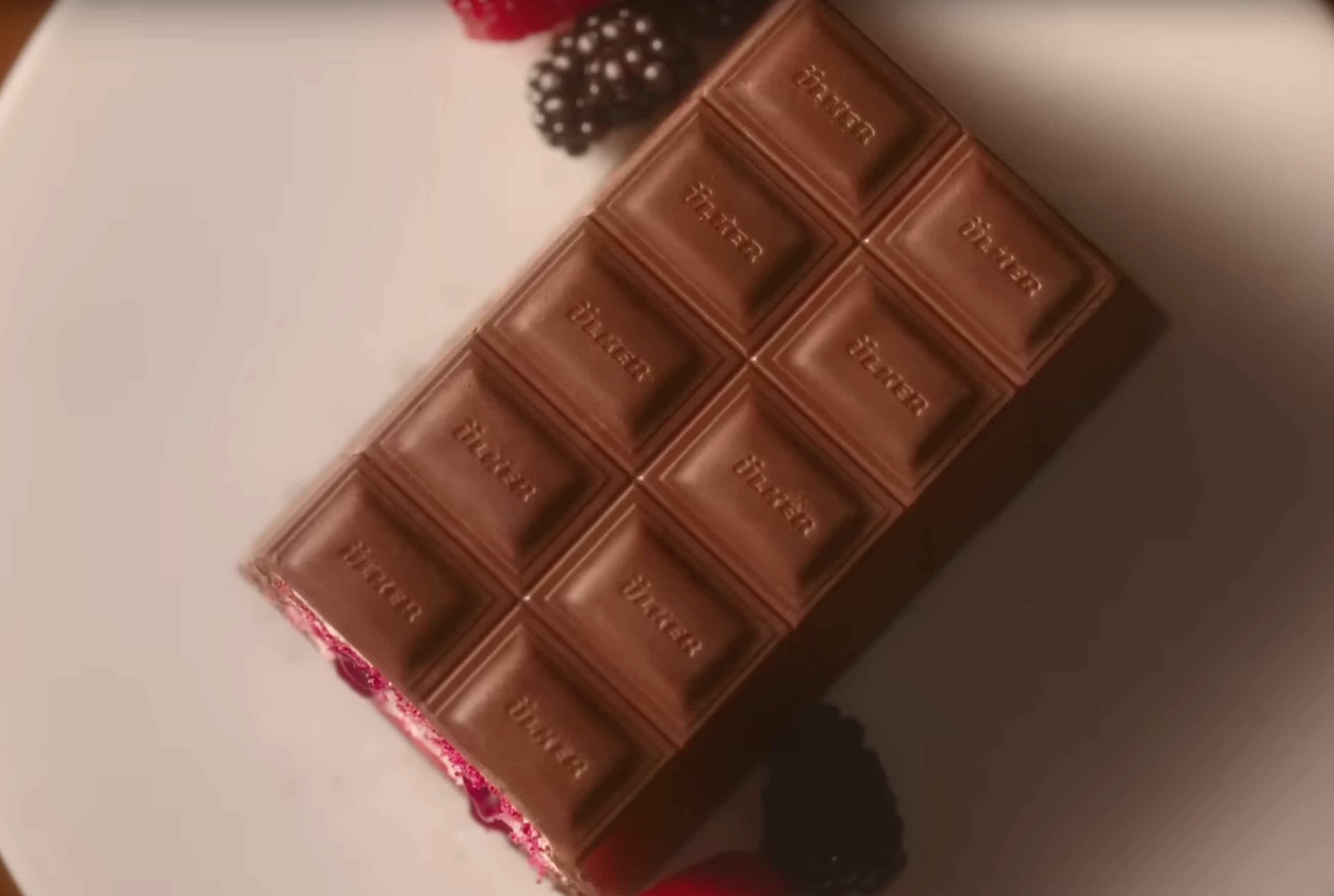 Chocolate bar with visible brand name on a white surface. Ulker Milk Chocolate Cake with Velvety Red Velvet Base and Forest Berry Sauce – 13.9 oz (395 G)