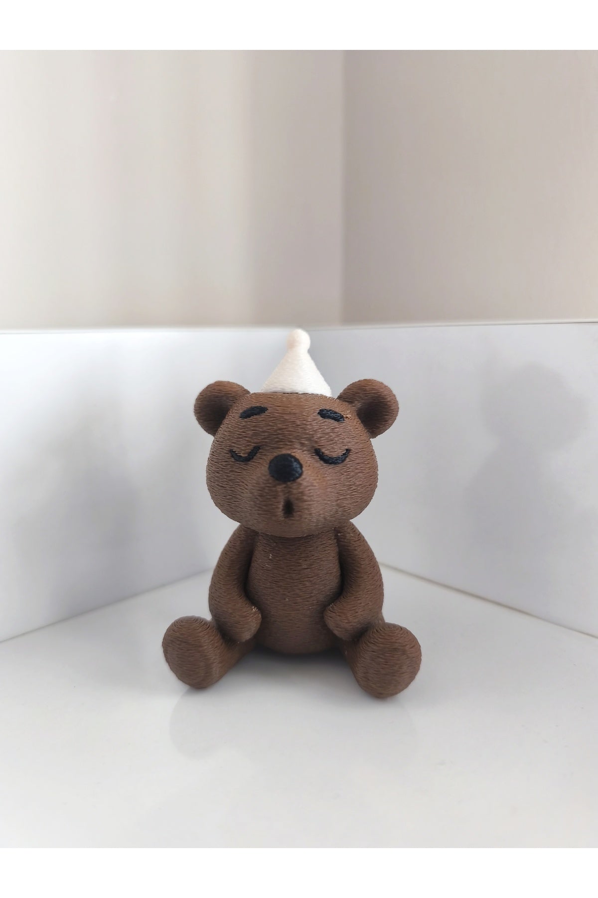 Add a playful touch to your space with the Alwin3d Cute Sitting Bear Blowing Candle Figurine Toy.