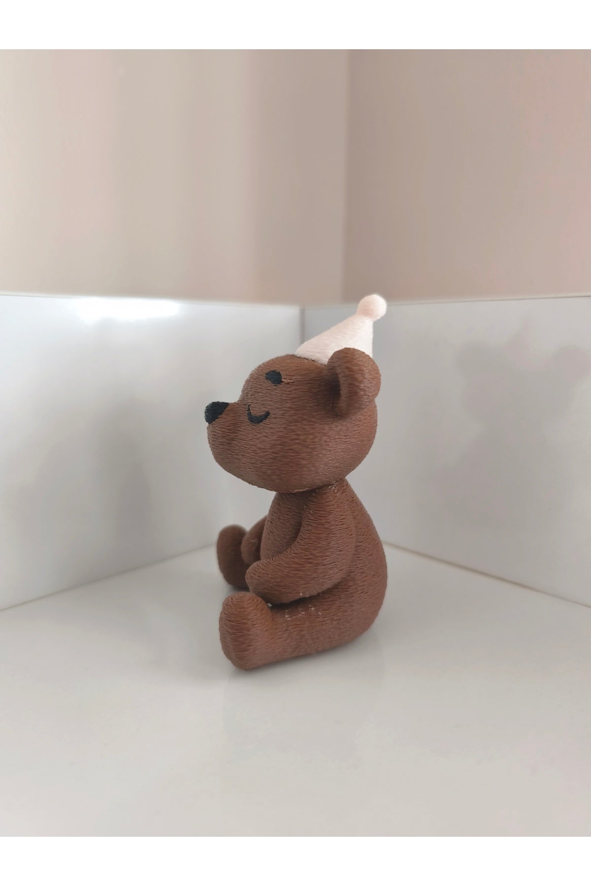Add a playful touch to your space with the Alwin3d Cute Sitting Bear Blowing Candle Figurine Toy.