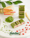 Two pieces of Beyoglu Matchico Matcha Chocolate- Matcha-infused white chocolate filled with raspberry cream and strawberry pieces