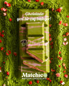 Two pieces of Beyoglu Matchico Matcha Chocolate- Matcha-infused white chocolate filled with raspberry cream and strawberry pieces