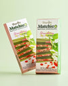 Two pieces of Beyoglu Matchico Matcha Chocolate- Matcha-infused white chocolate filled with raspberry cream and strawberry pieces