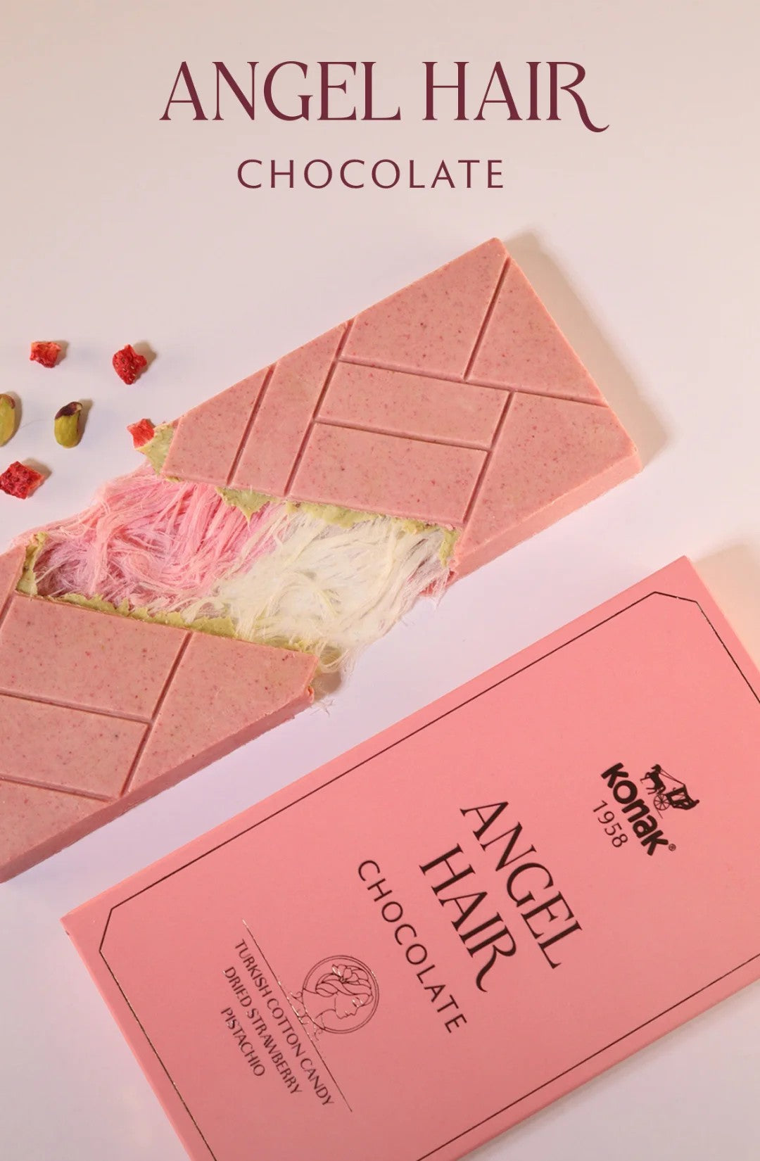 A gourmet pistachio cream chocolate bar by Konak, showcasing a soft, silky white chocolate base and delicate pişmaniye (cotton candy) texture.