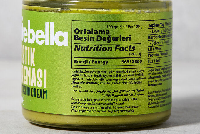 Jar of Rebella pistachio cream with green label on a white background showing the nutrition facts of Antebella