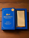 Blue packaging of Senso Gusto Chocolatier Dubai Chocolate with Pistachio on a neutral background