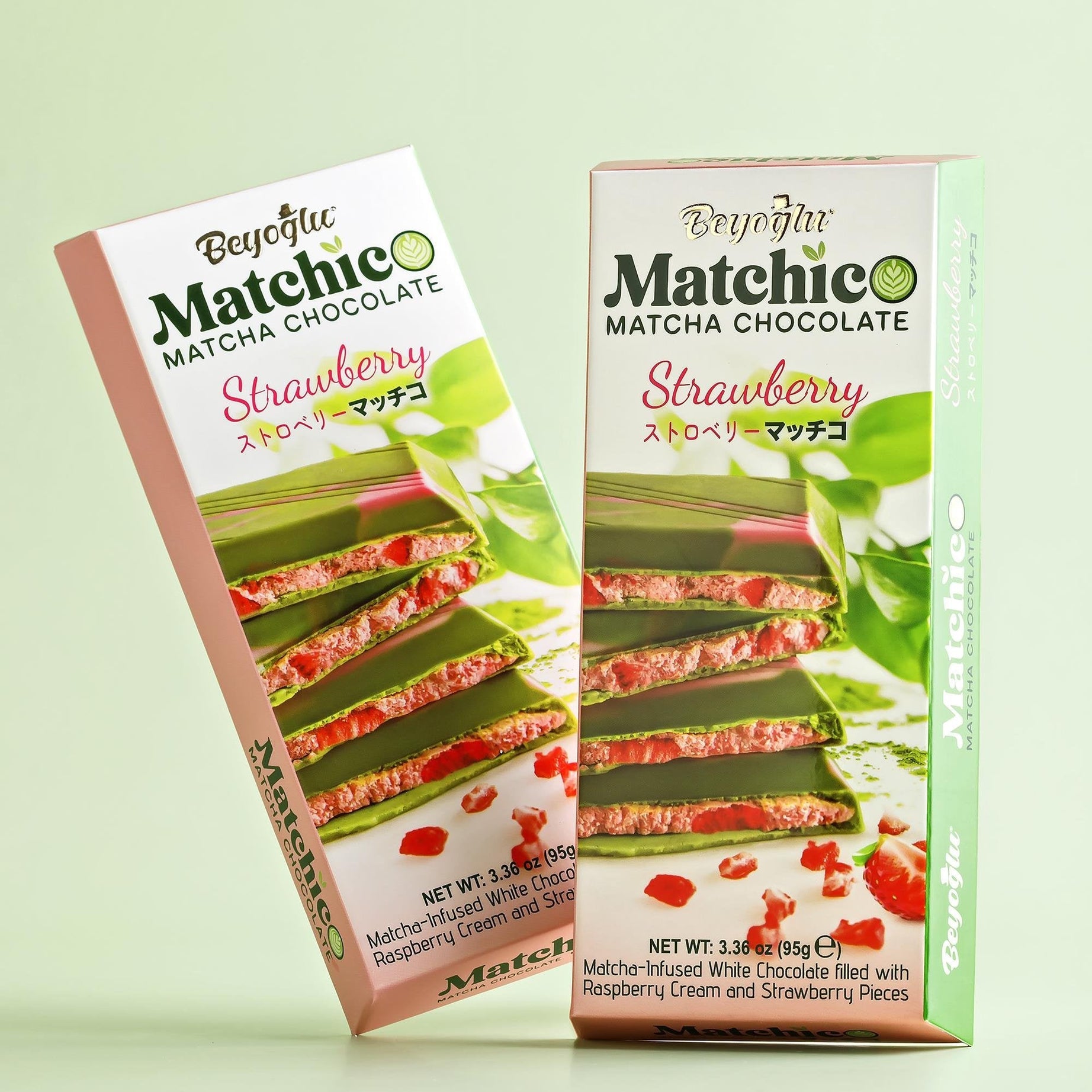 Two pieces of Beyoglu Matchico Matcha Chocolate- Matcha-infused white chocolate filled with raspberry cream and strawberry pieces