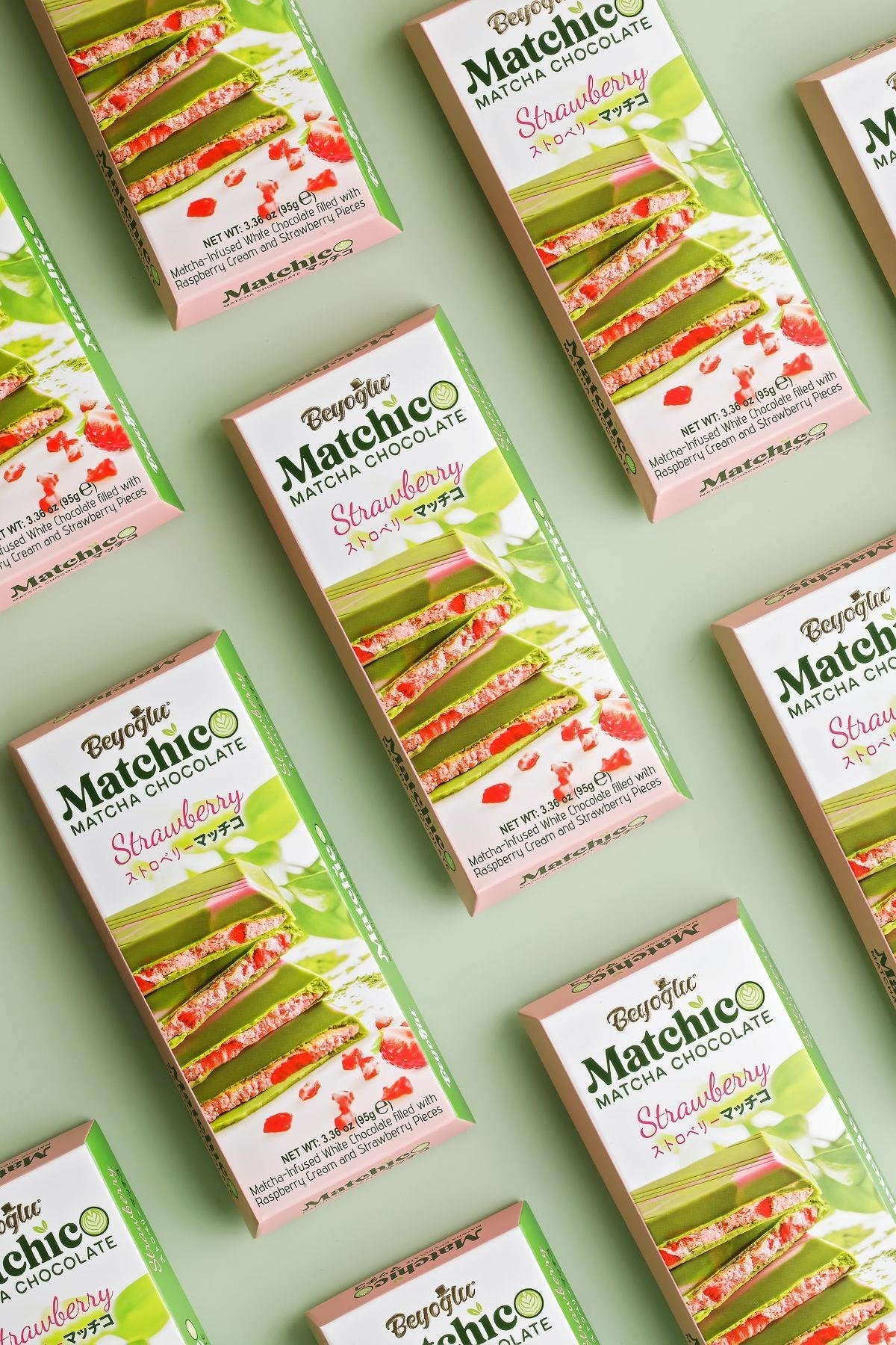 Close-up of matcha-infused white chocolate filled with creamy raspberry and dried strawberry bits