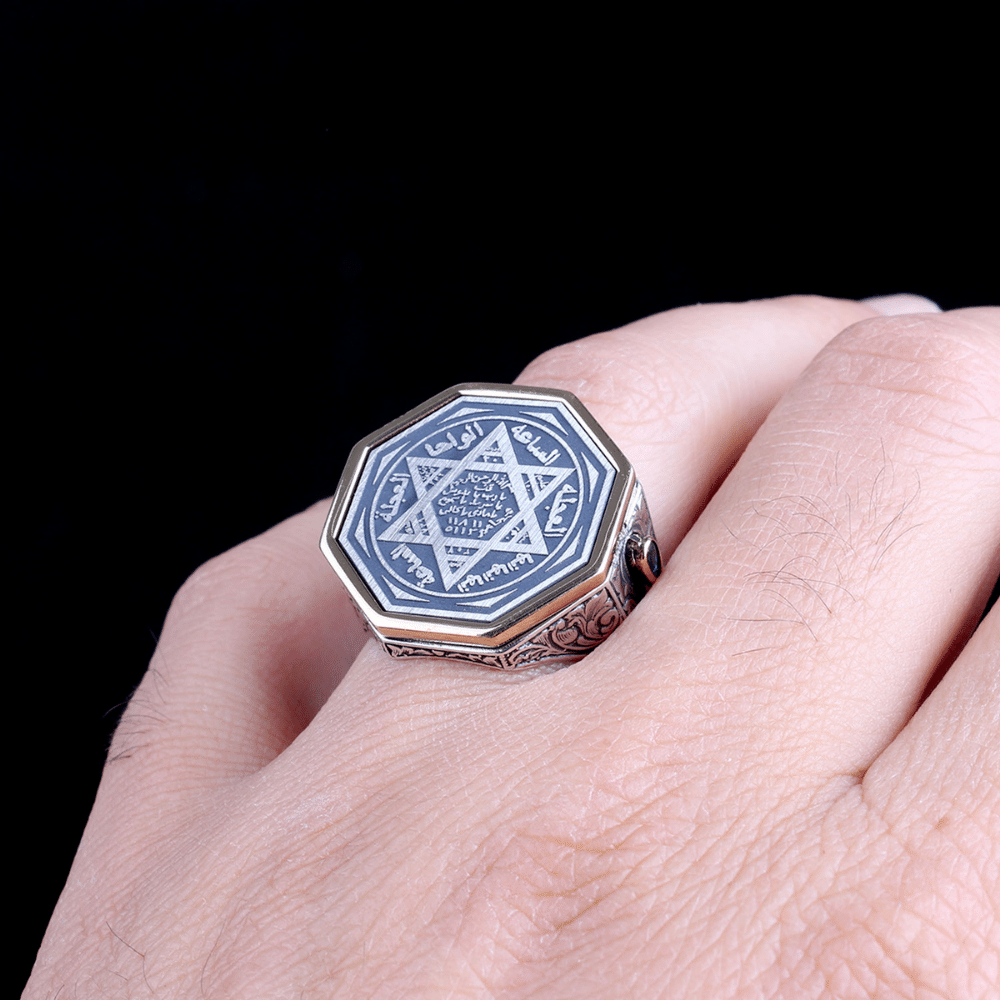 Crafted from solid 925 Sterling Silver, this Turkish Sterling Silver Ring with Blue Suleiman Seal features intricate engraved detailing and a striking blue stone accent at its center.