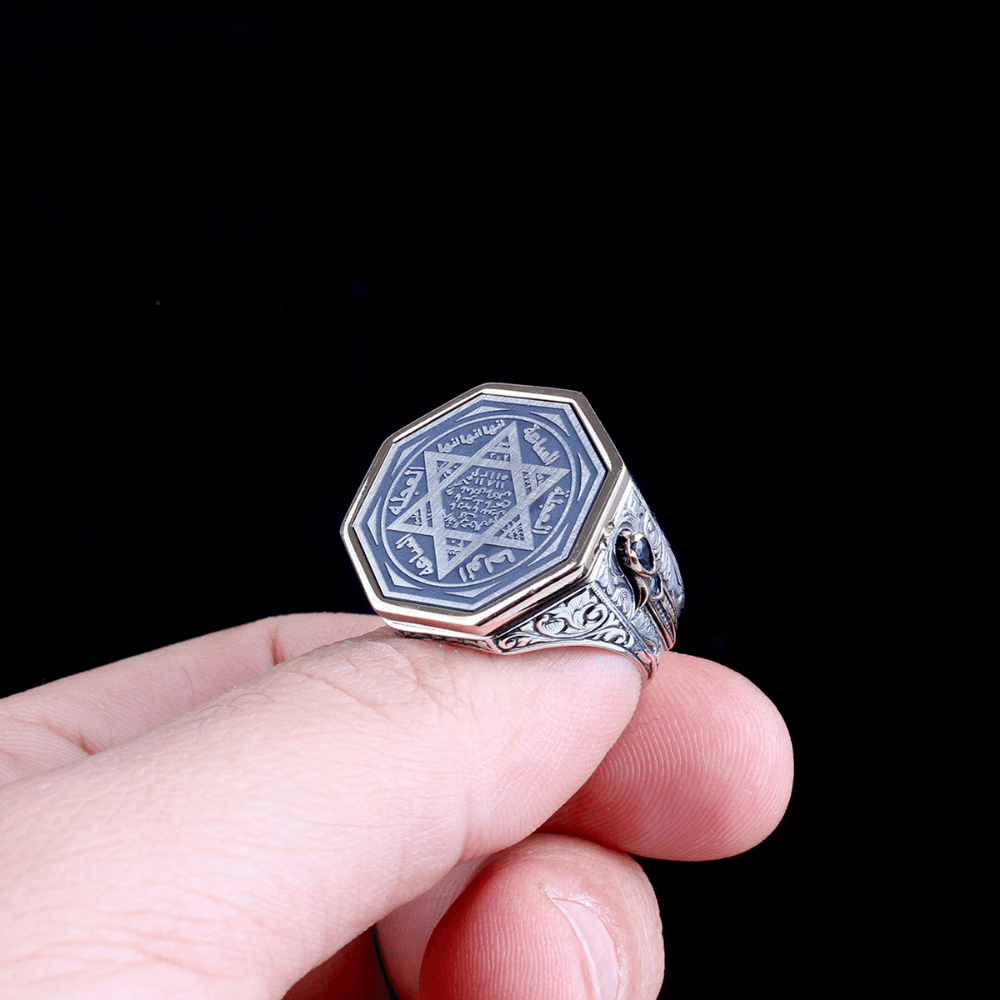 Crafted from solid 925 Sterling Silver, this Turkish Sterling Silver Ring with Blue Suleiman Seal features intricate engraved detailing and a striking blue stone accent at its center.